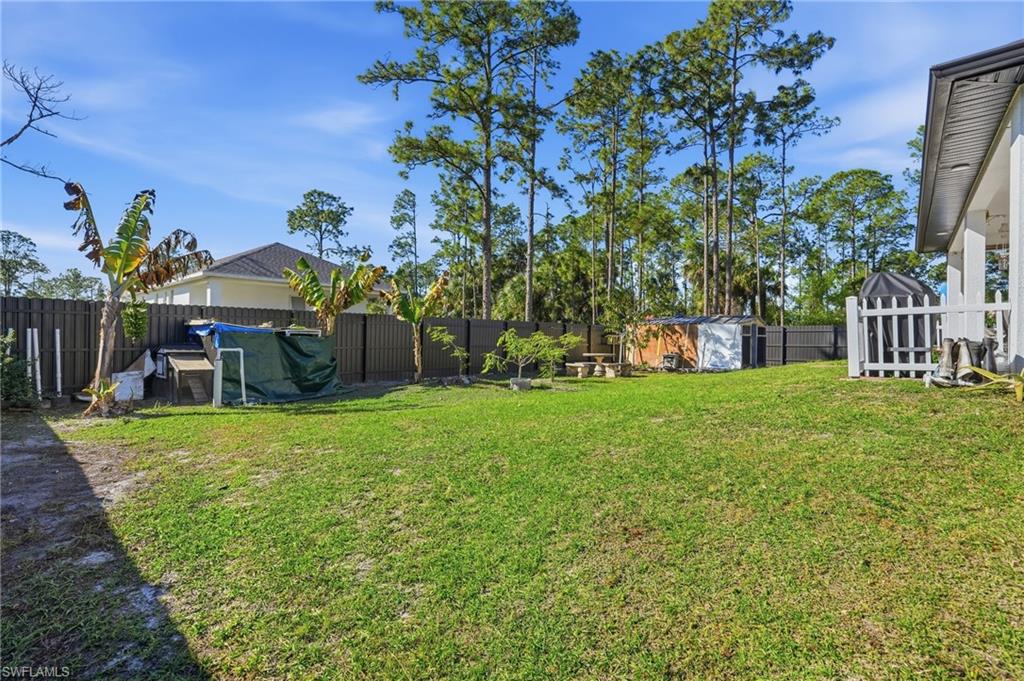 3409 64th Street West Lehigh Acres, FL 33971 - Photo 36 of 44 a view of a house with a back yard