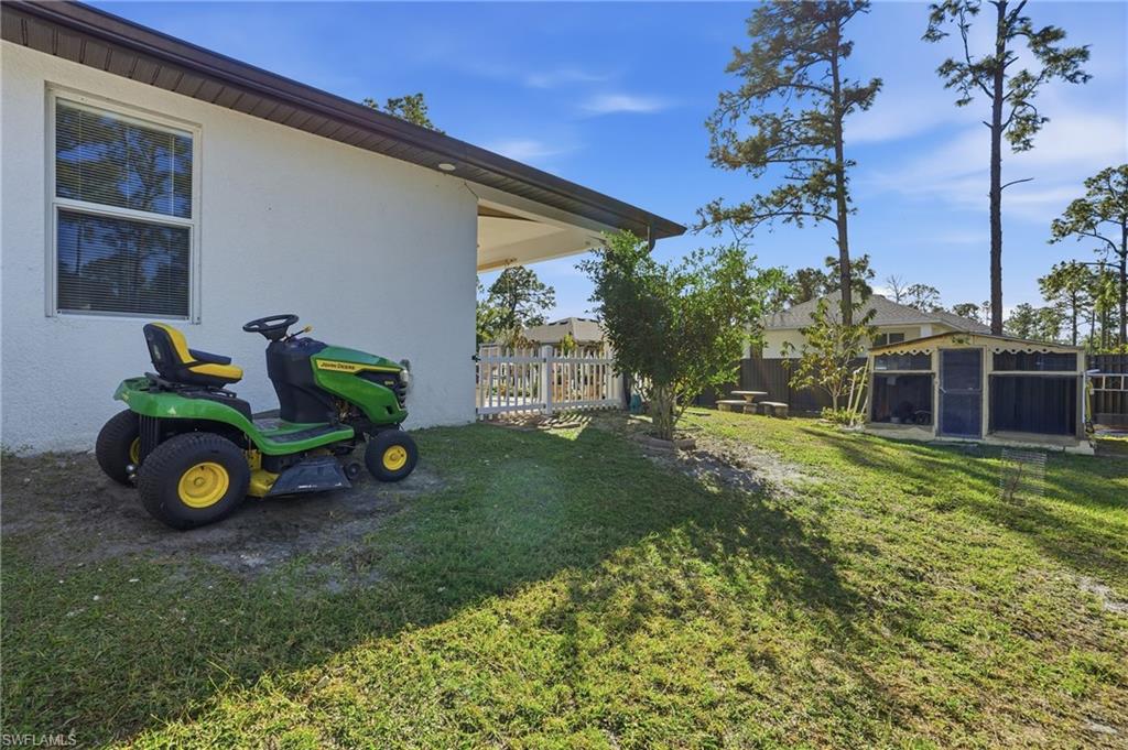 3409 64th Street West Lehigh Acres, FL 33971 - Photo 37 of 44 a view of a house with a backyard
