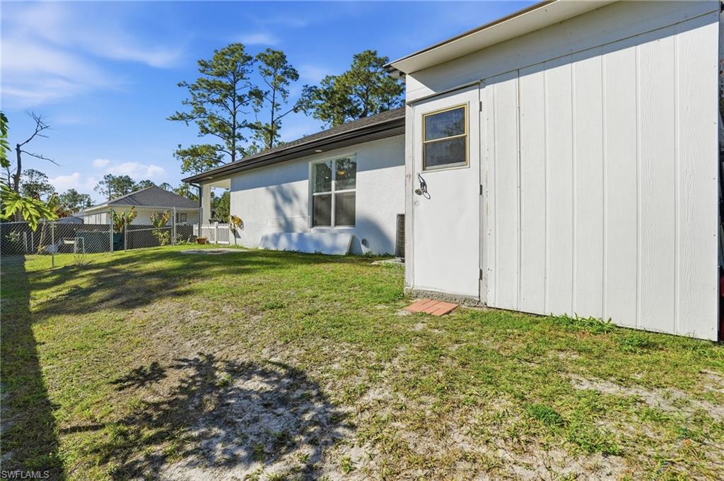 3409 64th Street West Lehigh Acres, FL 33971 - Photo 38 of 44 a view of a house with a yard