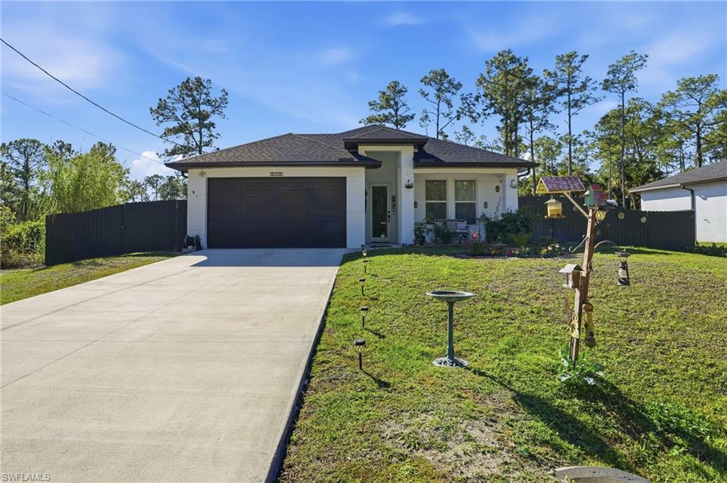 3409 64th Street West Lehigh Acres, FL 33971 - Photo 39 of 44 front view of a house with a yard