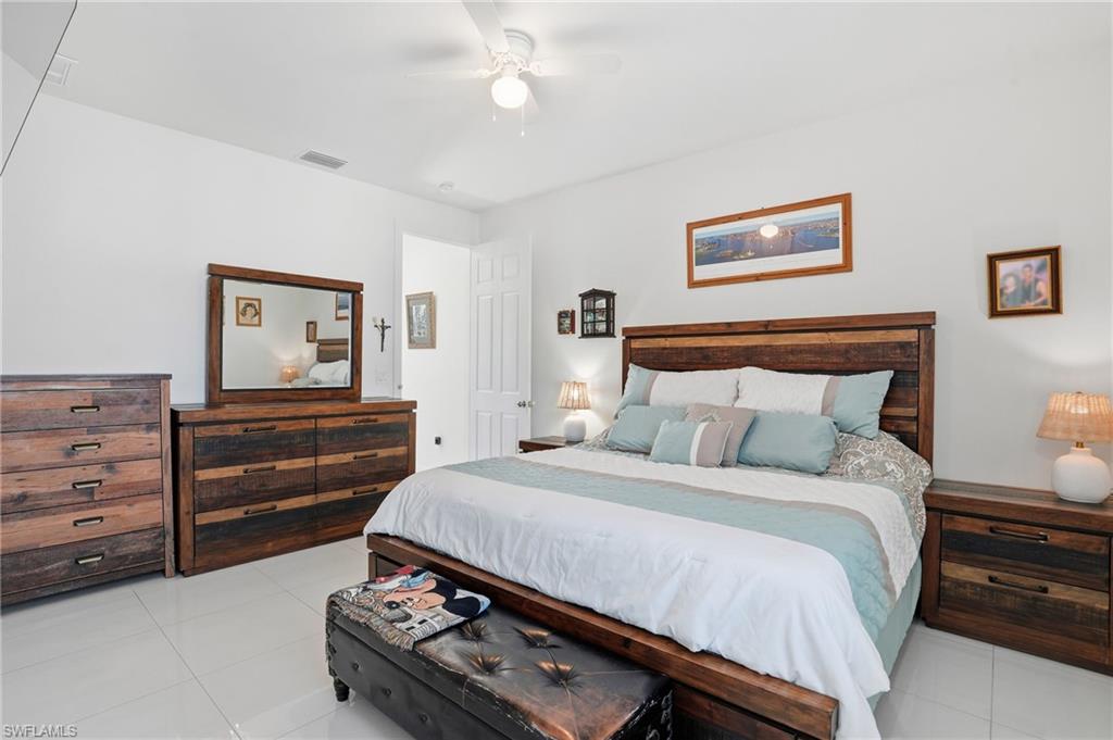 3409 64th Street West Lehigh Acres, FL 33971 - Photo 4 of 44 a bedroom with a bed and a dresser