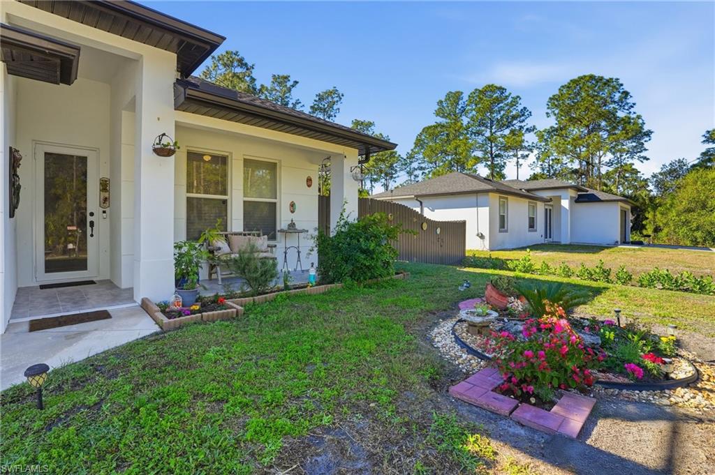 3409 64th Street West Lehigh Acres, FL 33971 - Photo 41 of 44 front view of a house and a yard