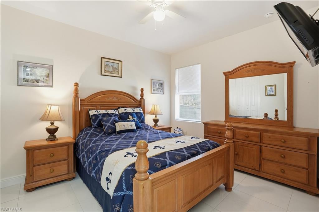 3409 64th Street West Lehigh Acres, FL 33971 - Photo 6 of 44 a bed room with a bed and a television