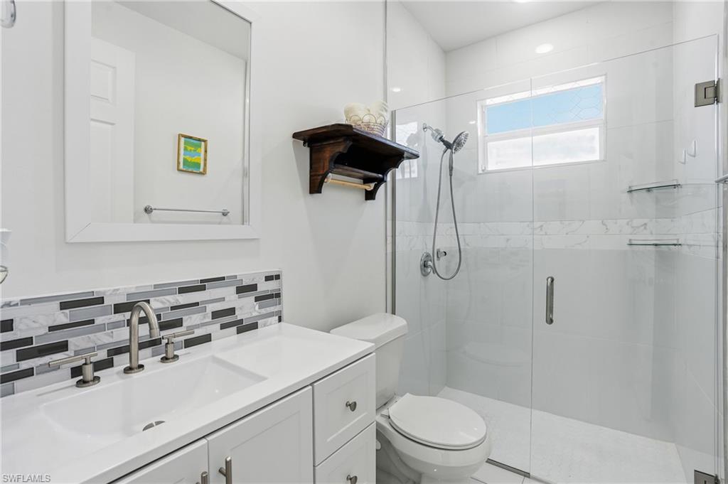 3409 64th Street West Lehigh Acres, FL 33971 - Photo 7 of 44 a bathroom with a sink toilet and shower