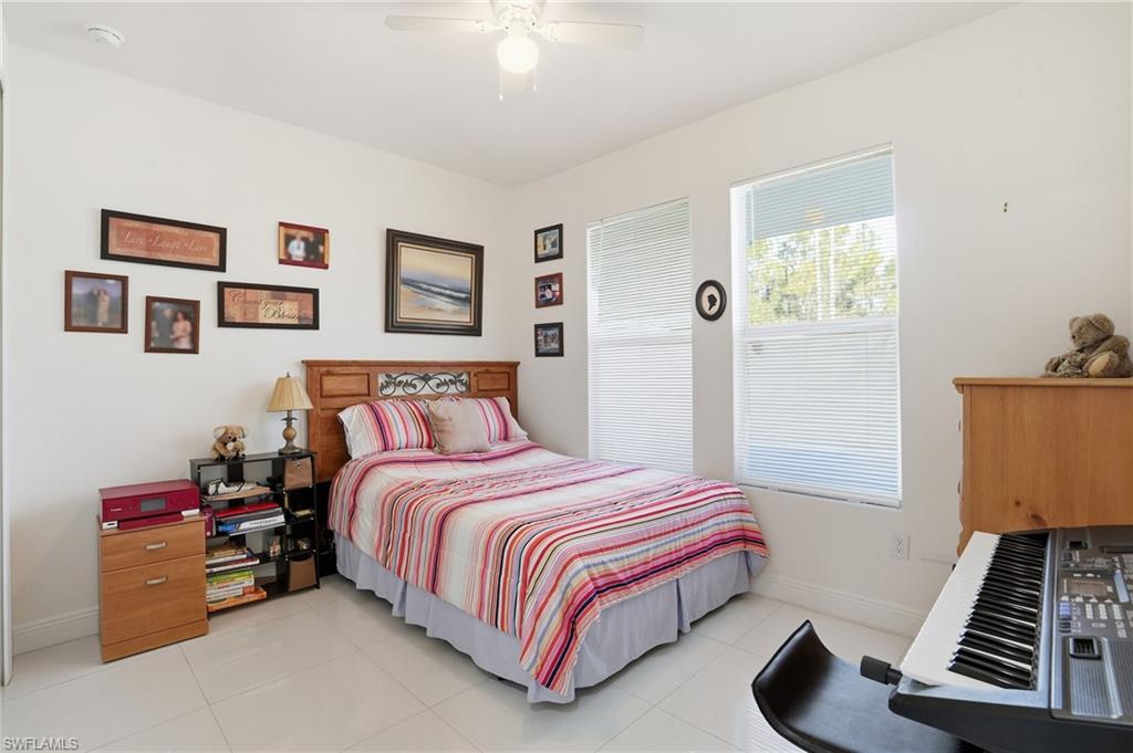 3409 64th Street West Lehigh Acres, FL 33971 - Photo 8 of 44 a bedroom with a bed and a window