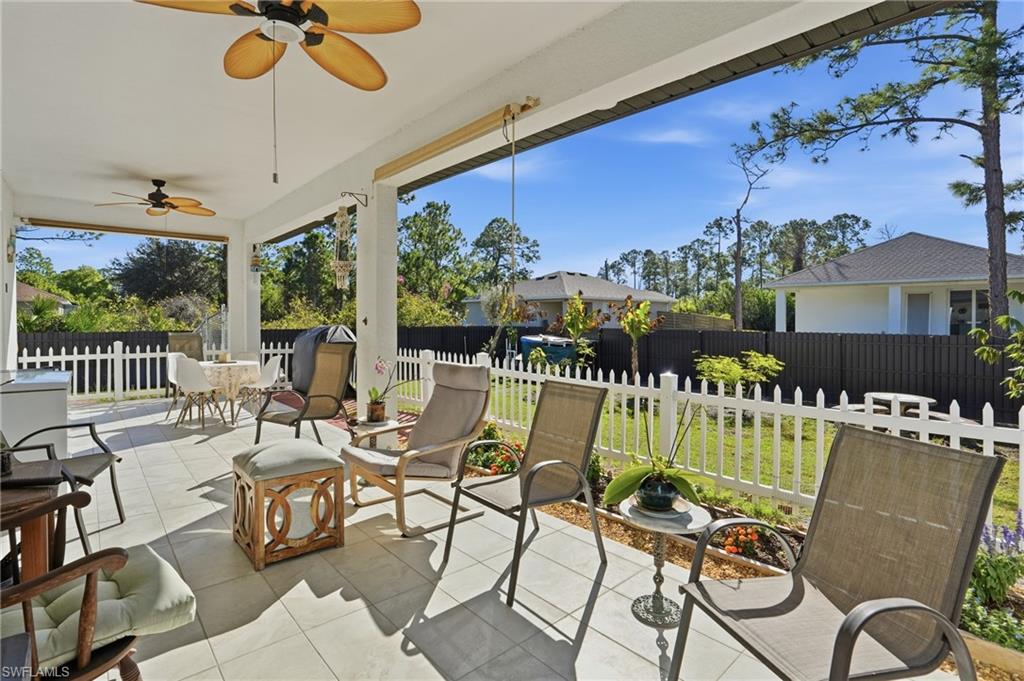 3409 64th Street West Lehigh Acres, FL 33971 - Photo 10 of 44 a view of a chairs and table in patio