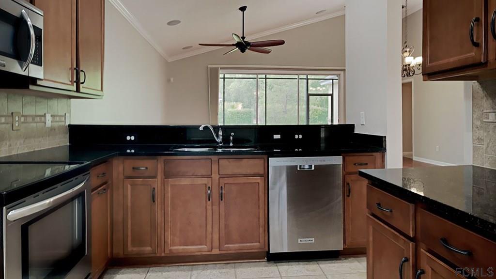 1504 Valhalla Way St. Augustine, FL 32092 - Photo 4 of 16 a kitchen with granite countertop a sink stainless steel appliances and cabinets