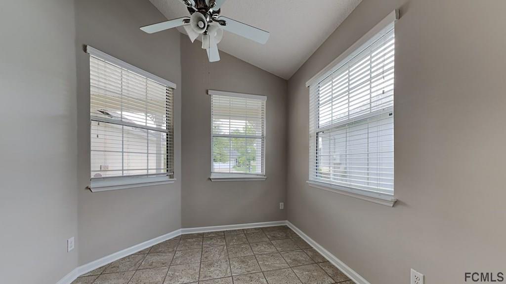 1504 Valhalla Way St. Augustine, FL 32092 - Photo 5 of 16 an empty room with windows and chandelier fan