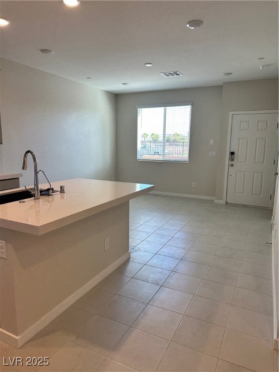 860 Angwin Lane Henderson, NV 89011 - Photo 3 of 9 Kitchen featuring light tile patterned flooring, recessed lighting, and a center island with sink
