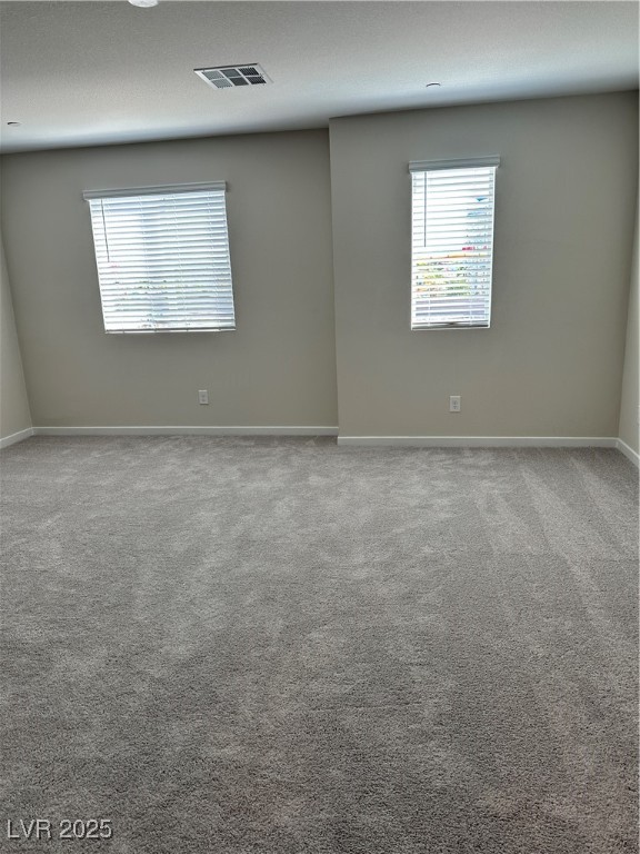 860 Angwin Lane Henderson, NV 89011 - Photo 7 of 9 Empty room with light carpet and baseboards