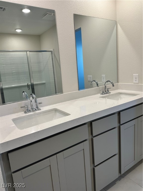 860 Angwin Lane Henderson, NV 89011 - Photo 9 of 9 Full bathroom with a shower stall, double vanity, a textured wall, and recessed lighting