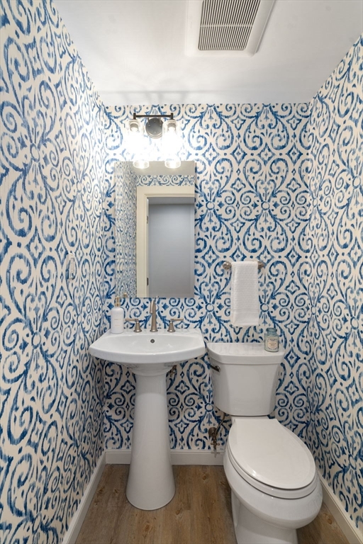 65 Grove Wellesley Ma, Unit 152 Wellesley, MA 02482 - Photo 11 of 16 a white toilet sitting next to a bathroom sink