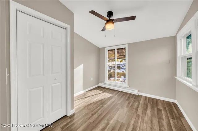 wooden floor in an empty room with a window