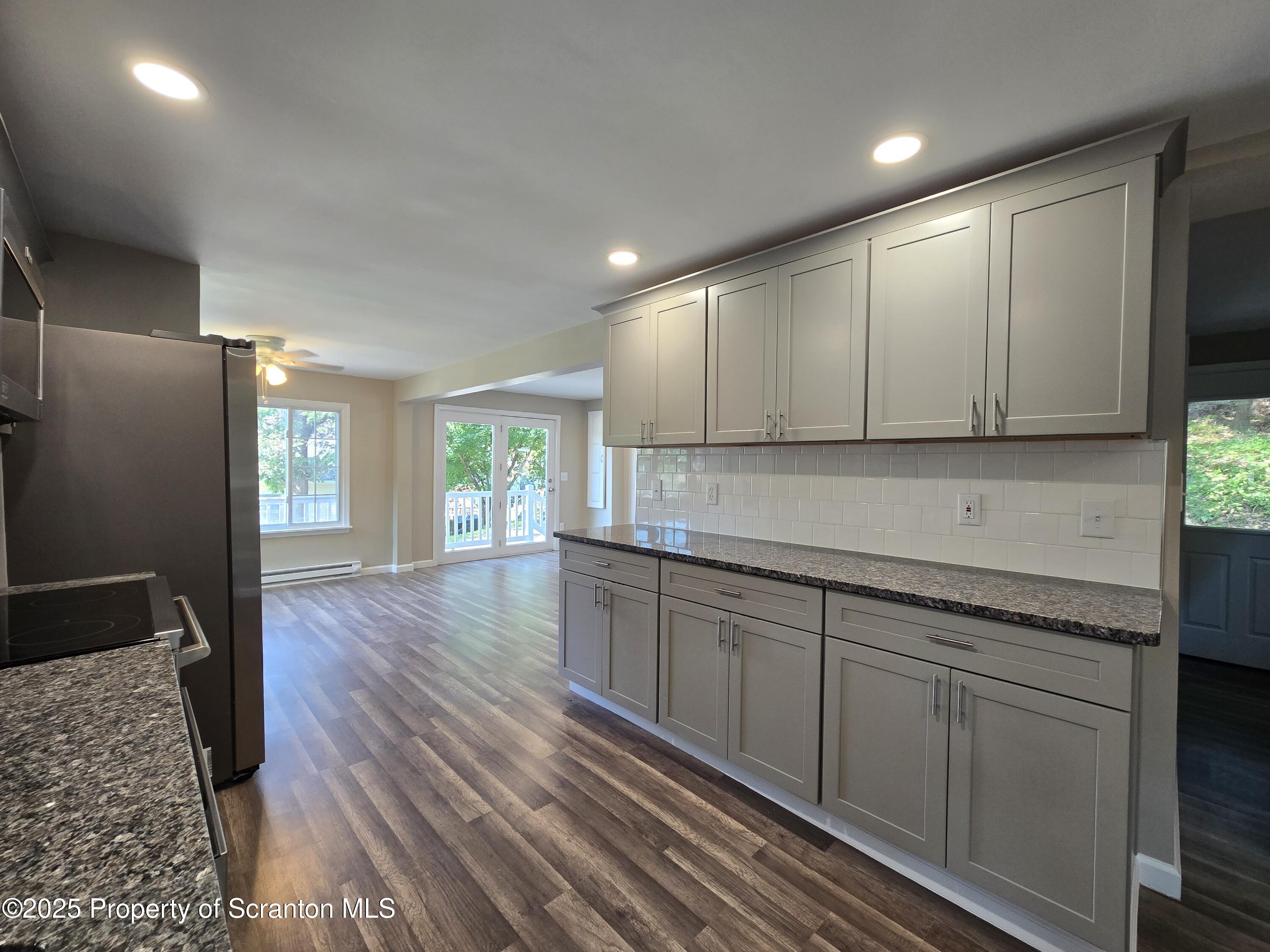 134 Chestnut Street Factoryville, PA 18419 - Photo 14 of 33 a kitchen with sink cabinets and wooden floor