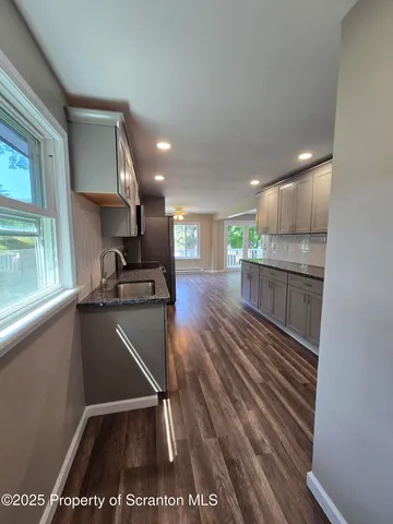 a kitchen with stainless steel appliances granite countertop a refrigerator and a sink