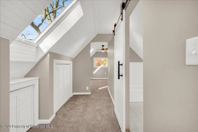 a view of a hallway view with wooden floor and staircase