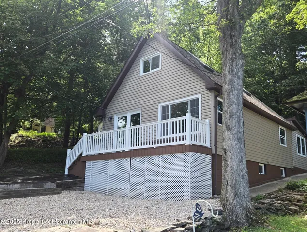 a view of a house with a yard and tree s