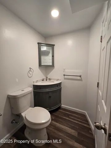 a bathroom with a toilet a sink and mirror