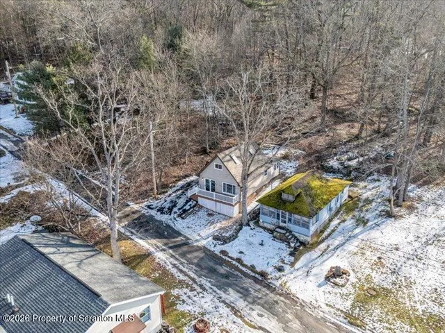 a view of a backyard with a small deck and a garden