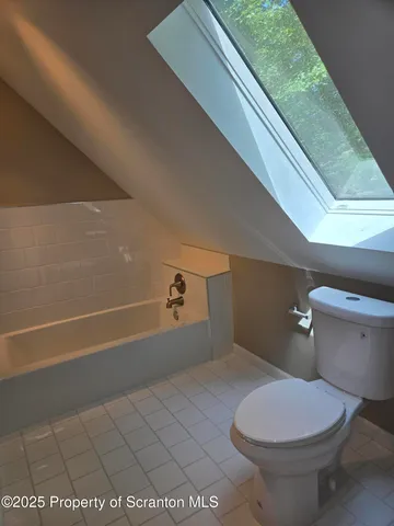 a bathroom with a toilet and a bathtub