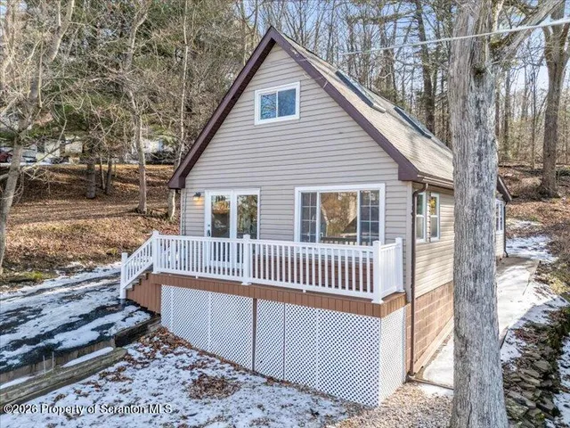 a view of a house with backyard and deck