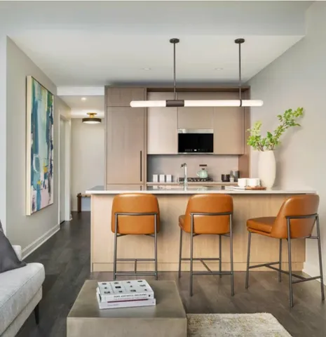 a outdoor kitchen with stainless steel appliances kitchen island granite countertop a table and chairs