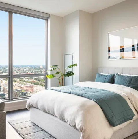 a bedroom with a large bed and a large window