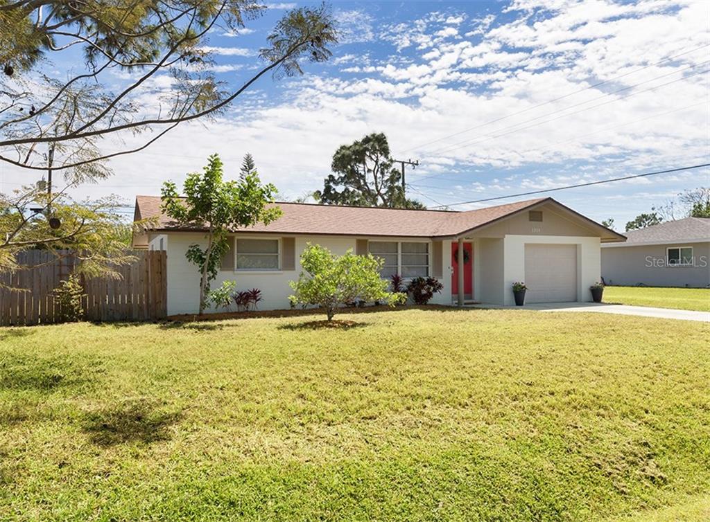 1019 Indus Road Venice, FL 34293 - Photo 1 of 1 a front view of a house with a garden and yard