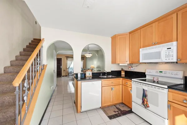 a patio with a table and chairs under an umbrella