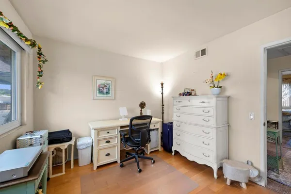 a front view of a house with a yard and trees