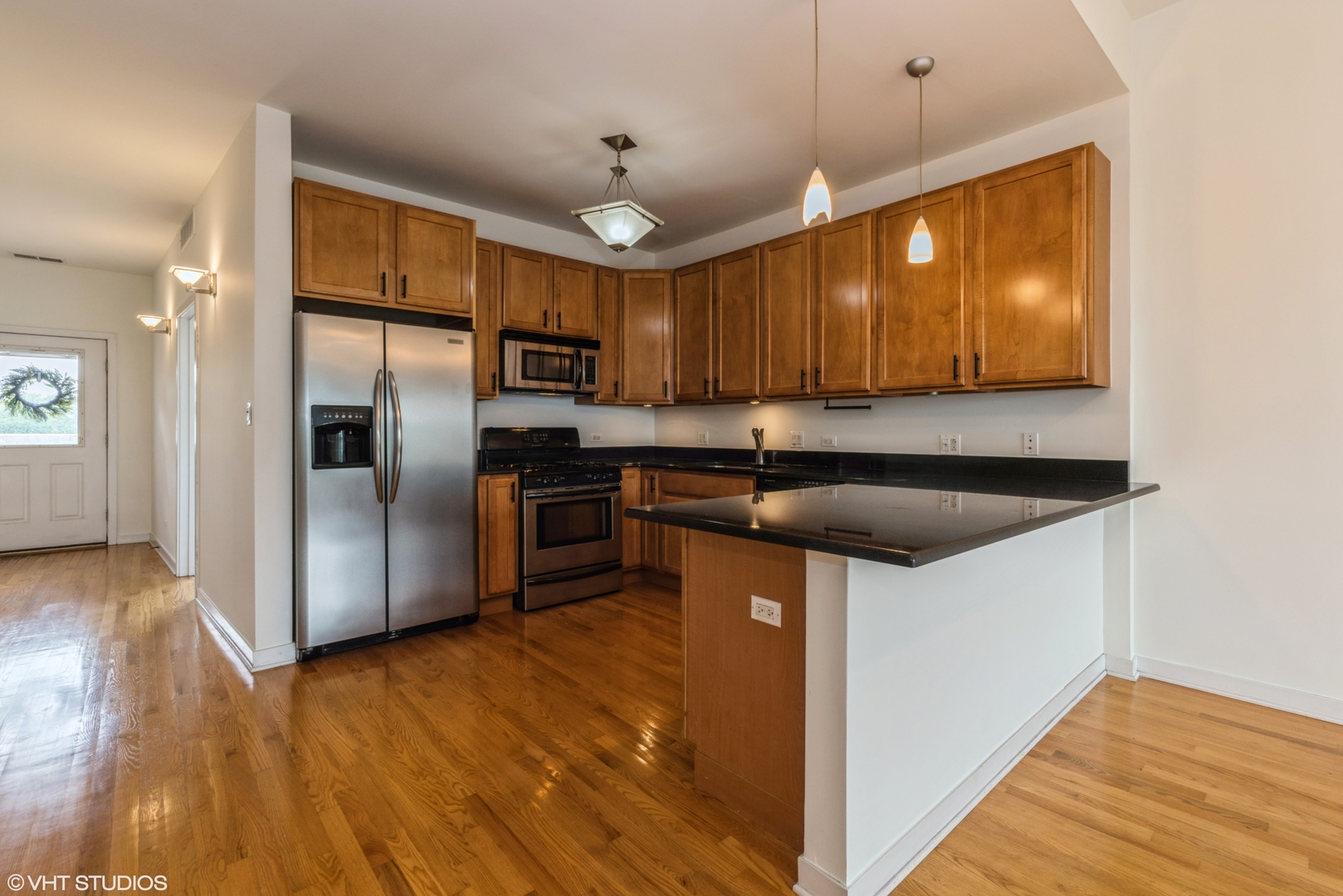 2510 West Irving Park Road, Unit 402 Chicago, IL 60618 - Photo 4 of 13 a kitchen with kitchen island a sink stainless steel appliances and cabinets
