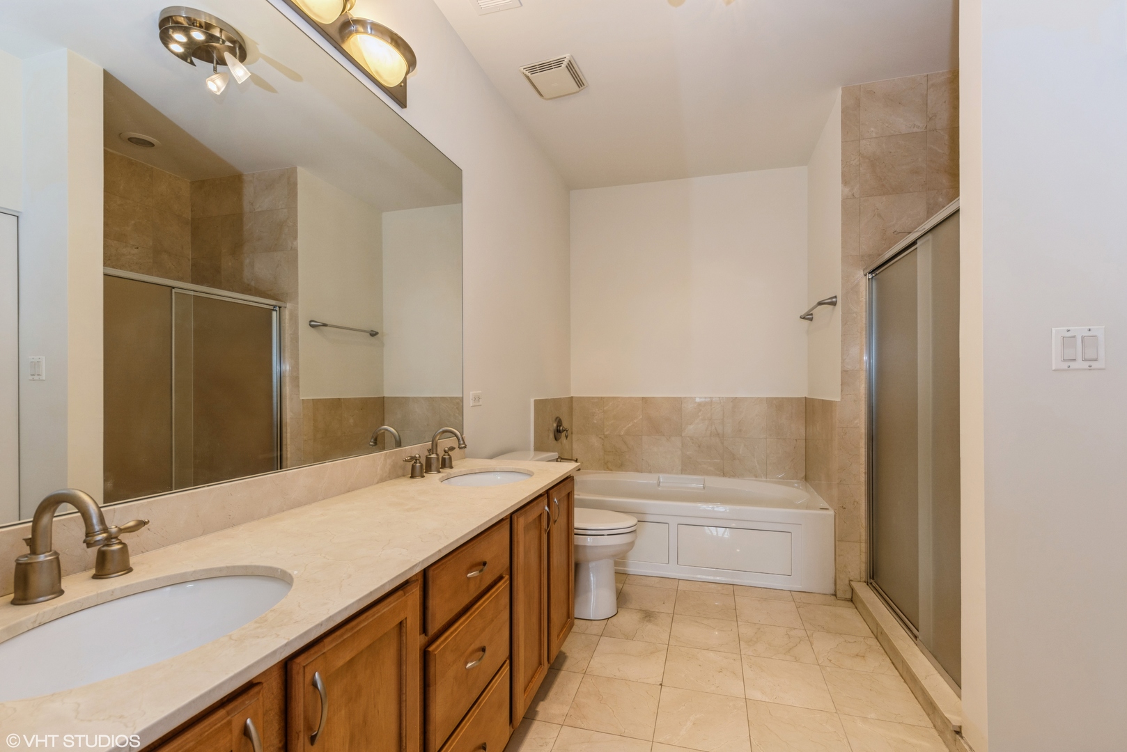 2510 West Irving Park Road, Unit 402 Chicago, IL 60618 - Photo 10 of 13 a bathroom with a sink a toilet and shower