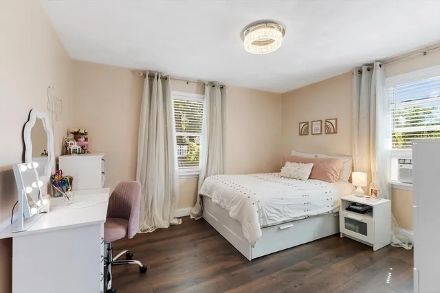 a bedroom with a large bed and a chandelier