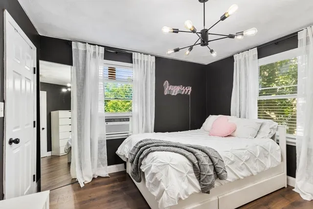 a front view of a house with a tree