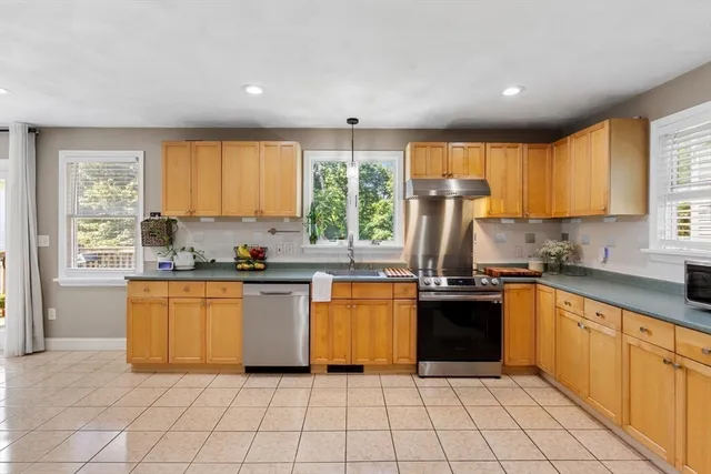 a view of a dining room with furniture and a large window