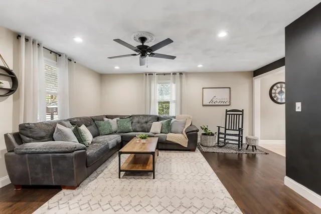 a living room with furniture and wooden floor