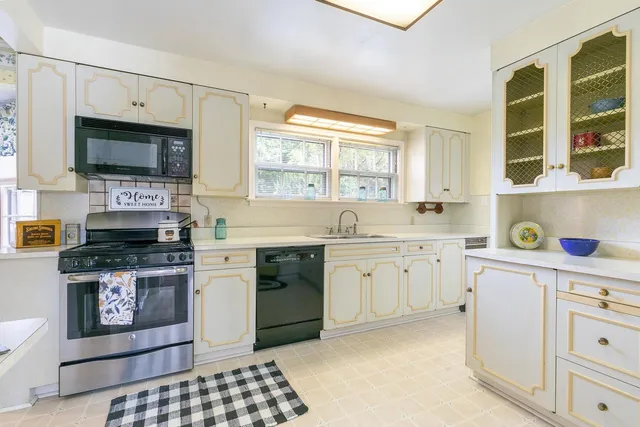 a kitchen with a stove a sink and a microwave
