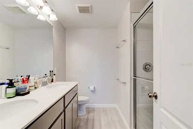 a bathroom with a sink vanity mirror and toilet