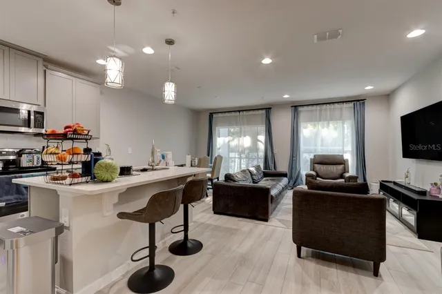 a view of a workspace with furniture and a flat screen tv