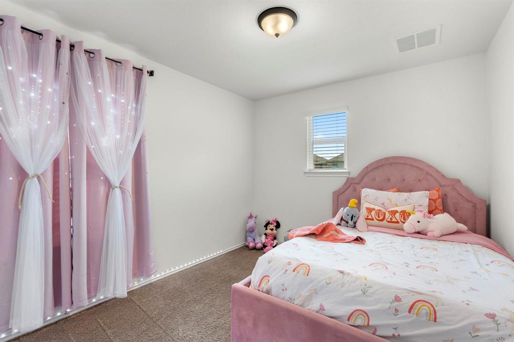 14100 Vigilance Street Manor, TX 78653 - Photo 25 of 32 a bedroom with a bed and a window