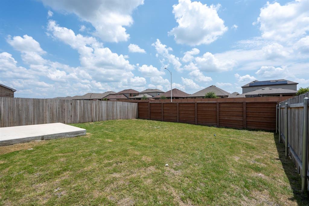 14100 Vigilance Street Manor, TX 78653 - Photo 29 of 32 a view of a backyard with wooden fence