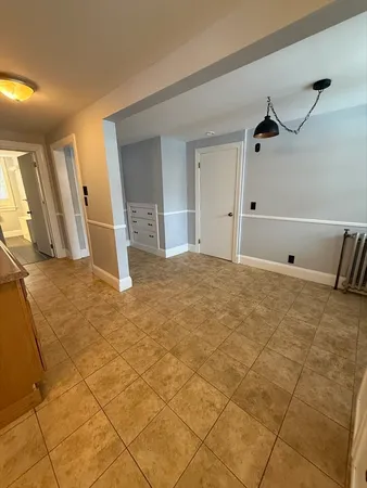 a view of a livingroom with an empty space and a window