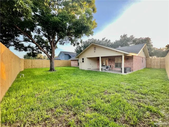 a view of a house with a backyard