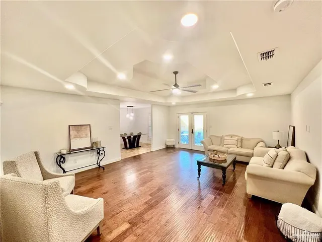 a living room with furniture and a wooden floor
