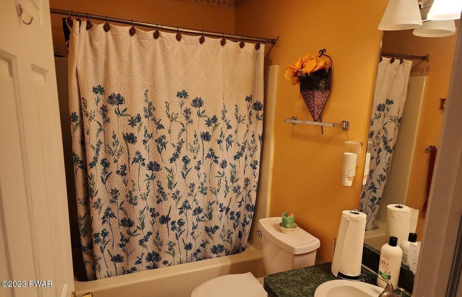 249 Pin Oak Road Stroudsburg, PA 18360 - Photo 25 of 34 a bathroom with a shower curtain and a toilet
