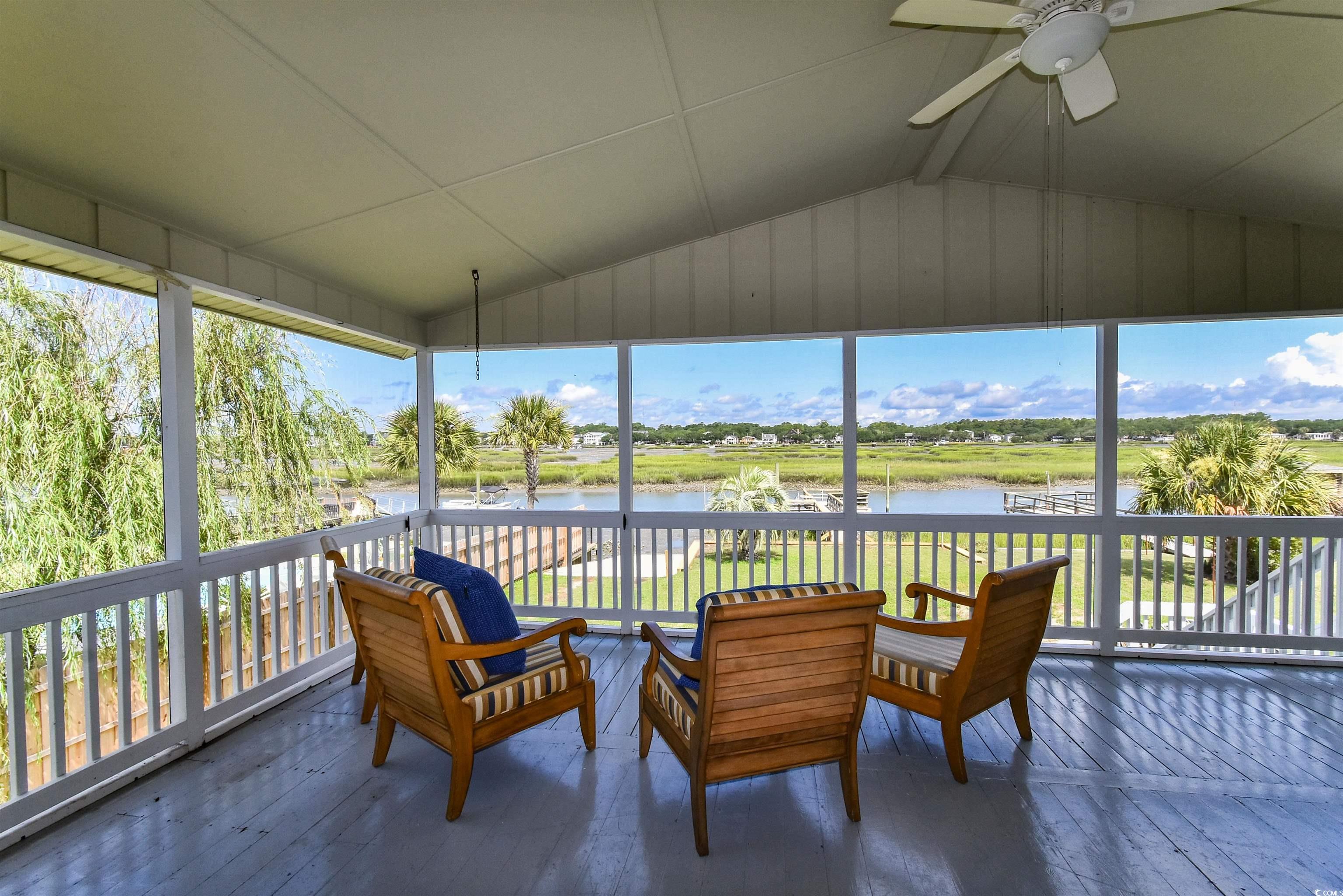 342 State Rd S-26-530 Murrells Inlet, SC 29576 - Photo 8 of 38 Sunroom featuring lofted ceiling, a wealth of natural light, ceiling fan, and a water view