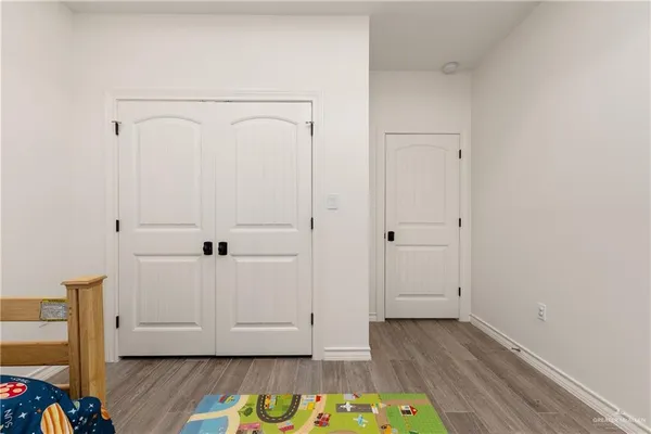 a view of walk in closet with wooden floor
