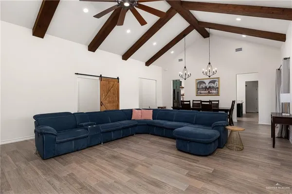 a living room with furniture and a wooden floor