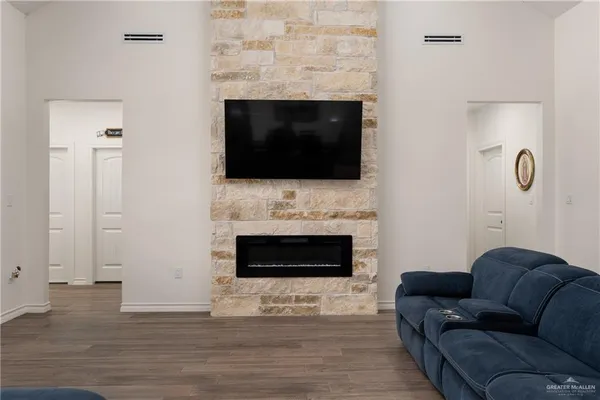 a living room with furniture a fireplace and a flat screen tv