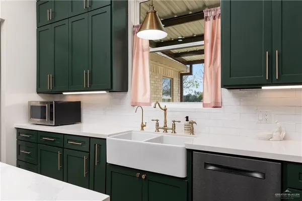 a kitchen with a sink cabinets and a wooden floor